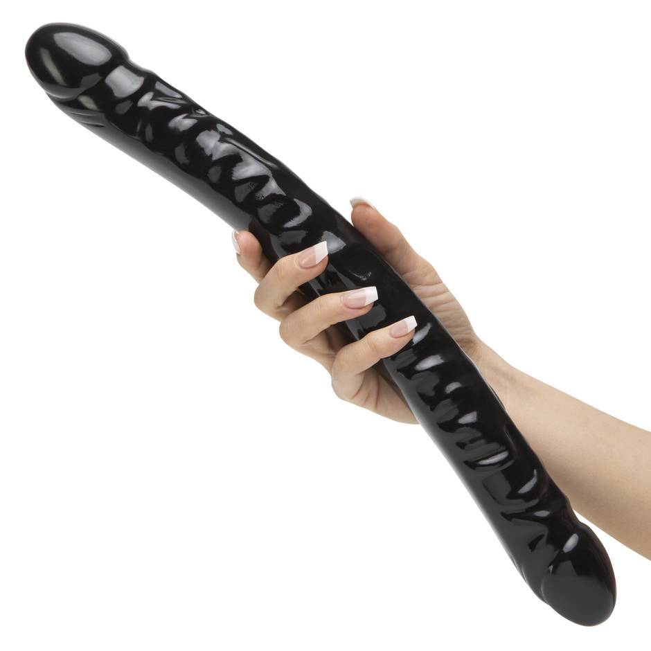 woman holding big black dildo