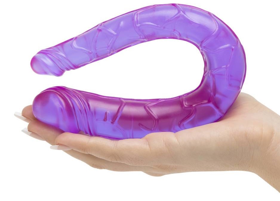 woman holding purple dildo