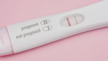 positive pregnancy test on pink background